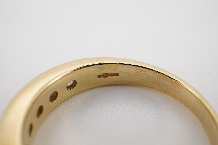 A modern 18ct gold and ten stone channel set diamond half hoop ring, size Q, gross weight 5.8 grams. Condition - fair to good